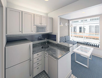 Kitchen with nearly full-sized refrigerator, sink, dishwasher and microwave.
